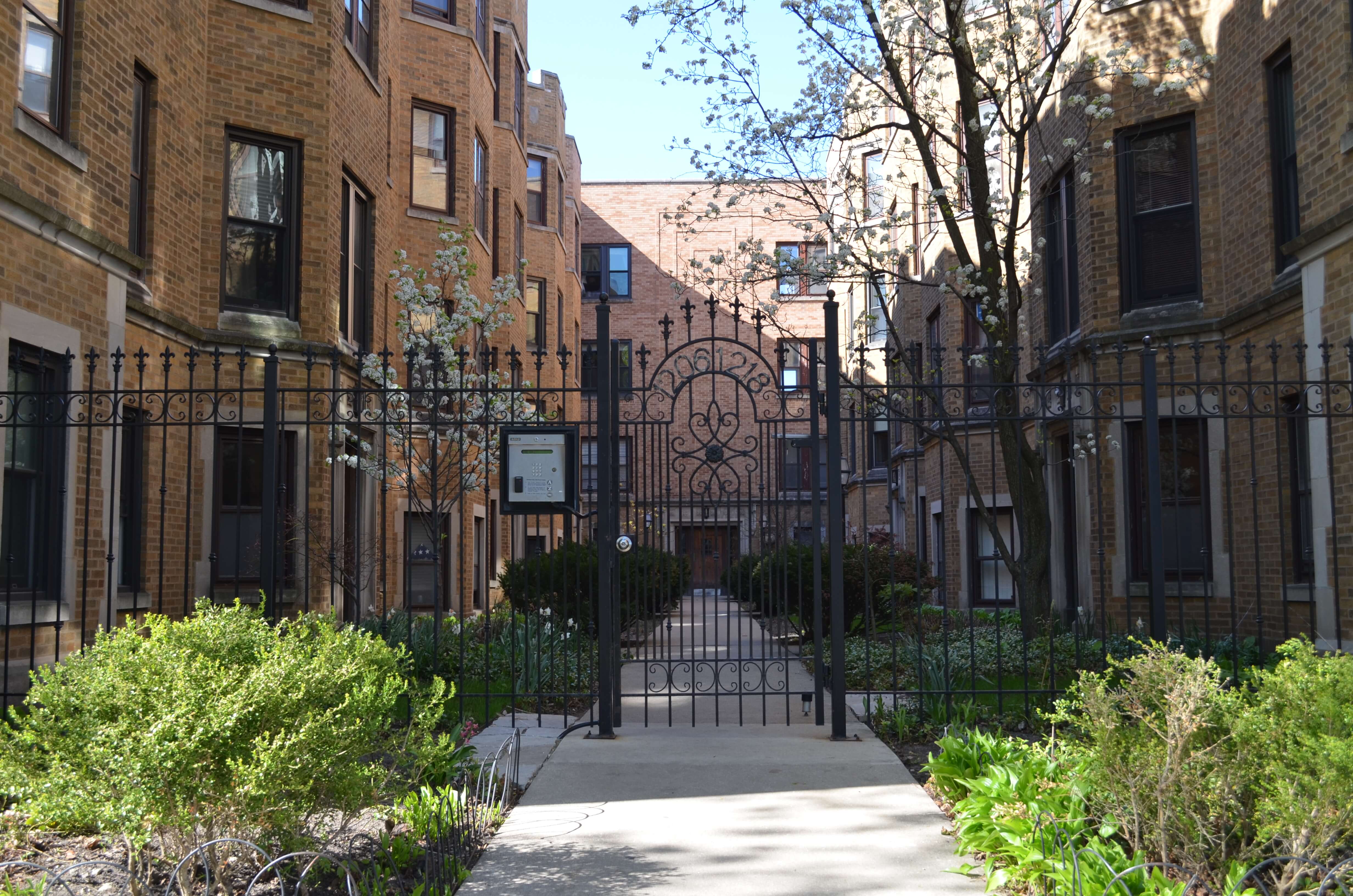 Gated entrance to a landscaped courtyard